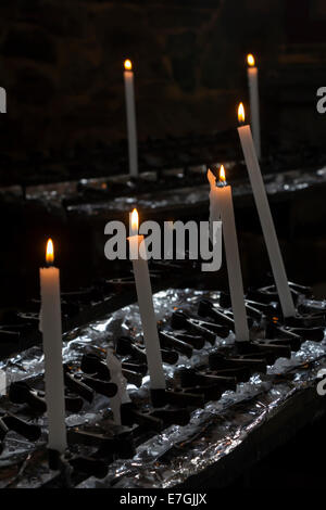 Un groupe de bougies allumées dans l'église Banque D'Images