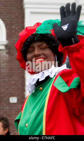 DORDRECHT, Pays-Bas - le 18 novembre : femme habillée en Zwarte Piet forme aux enfants dans un défilé dans les rues. Banque D'Images