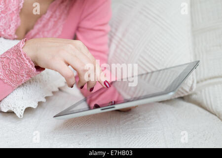 La femme de toucher du doigt de l'écran de l'appareil mobile et de choisir quelque chose dans la boutique Internet ou réseau social Banque D'Images