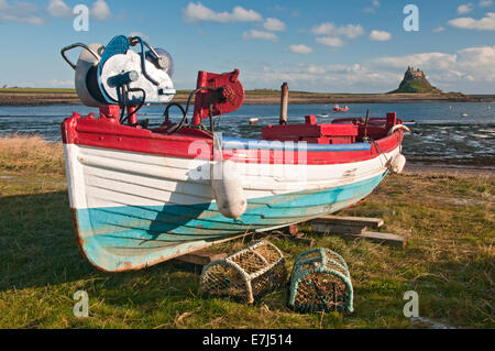 Bateau de pêche, des casiers à homard & Château de Lindisfarne, Holy Island, Northumberland, England, UK Banque D'Images