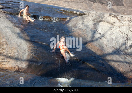 Les enfants sur les toboggans, le Parc National de Girraween, Granite Belt, Queensland, Australie Banque D'Images