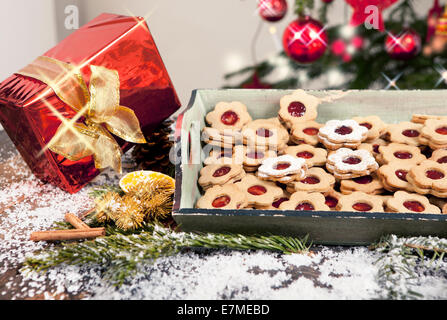 Biscuits et de cadeaux se trouvent sur une table avec de la neige et des branches de pins, dans l'arrière-plan d'un arbre de Noël Banque D'Images