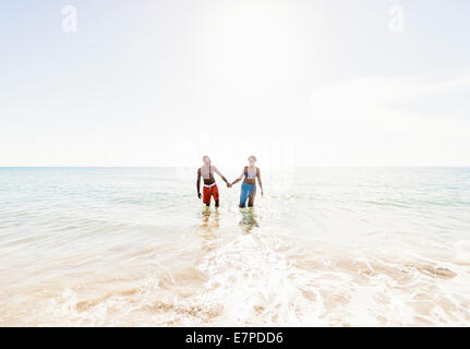 Man and Woman holding hands on beach Banque D'Images