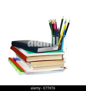 Ordinateur portable et des manuels scolaires en pile et verre avec crayons isolé sur fond blanc Banque D'Images