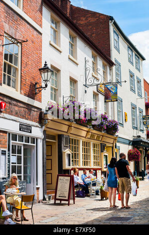 Les gens assis à l'extérieur des pubs et cafés dans Butcher Row, Shrewsbury, Shropshire, Angleterre. Banque D'Images