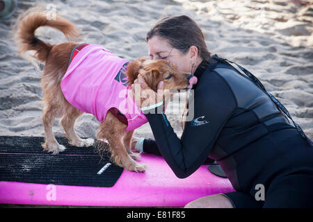 Huntington Beach, CA, USA. 28 Septembre, 2014. Un doux moment entre un concurrent et chien-chien à Surf City Surf Dog™ canine annuelle concours de surf. Les chiens de toutes tailles 'accrocher 20' qui s'affronteront dans quatre divisions de classe de poids, ainsi qu'un tandem de la chaleur. Ils sont jugés d'une variété de compétences, y compris la durée de leur trajet et leur confiance au conseil. Credit : Andie Mills/Alamy Live News Banque D'Images