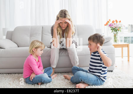 Assez de mère à l'écoute de ses jeunes enfants lutte Banque D'Images