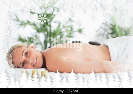 Smiling blonde woman having a stone therapy Banque D'Images