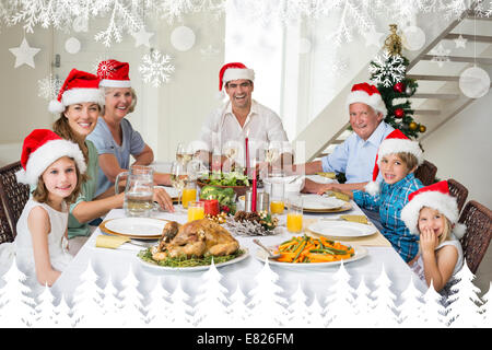 Image composite de happy family in santa hats christmas meal Banque D'Images