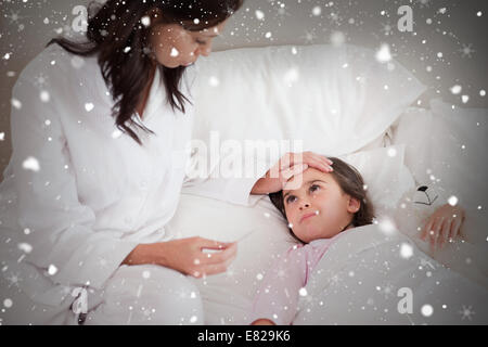 Image composite de mère contrôle de température sur ses filles Banque D'Images