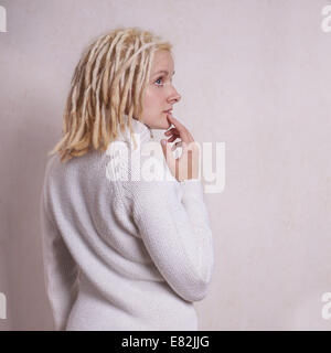 Pensive young woman with blonde dreadlocks Banque D'Images