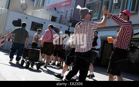 Munich, Allemagne. Sep 29, 2014. Un groupe d'hommes de Grande-Bretagne à pied à travers la ville avec un chariot avec deux caisses de bière avant la visite de l'Oktoberfest de Munich, Allemagne, 29 septembre 2014. Dpa : Crédit photo alliance/Alamy Live News Banque D'Images