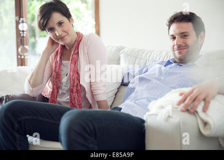 Couple relaxing on sofa Banque D'Images