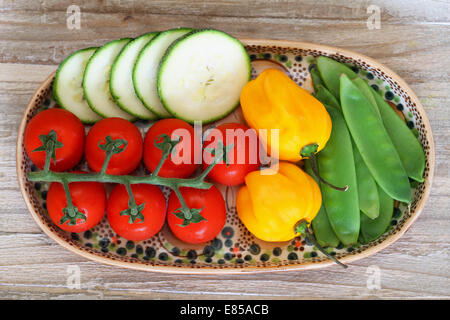 Tomates cerise, courgette, le sucre s'enclenche et adjuma poivrons sur la plaque sur la surface en bois Banque D'Images