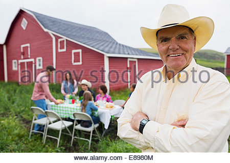 Portrait d'un ranch à dîner en famille à l'extérieur grange