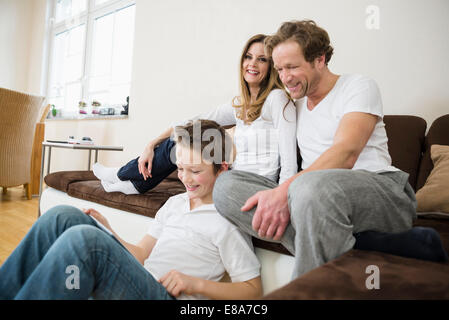 Happy Family in living room with digital tablet Banque D'Images