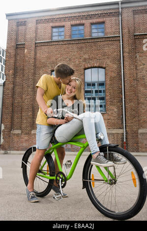 Teenage boy kissing woman, smiling Banque D'Images