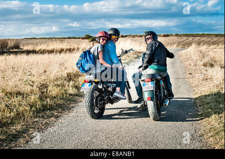 Vue arrière de trois amis sur des motos on rural road, Cagliari, Sardaigne, Italie Banque D'Images