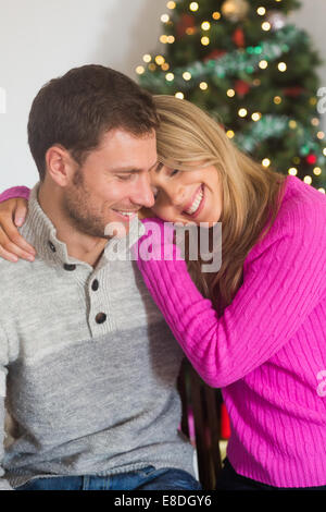 Smiling woman hugging her boyfriend Banque D'Images