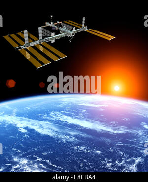 Photo de la NASA La Station spatiale internationale au-dessus de la terre flottant au coucher du soleil Banque D'Images