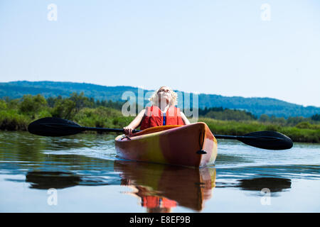 Jeune femme de détente sur un Kayak et profiter de l'instant de la Liberté Banque D'Images