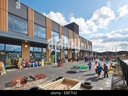 Oasis Academy Hadley, Enfield, Royaume-Uni. Architecte : John McAslan & Partners, 2013. Vue de la façade avec une aire de jeux. Banque D'Images