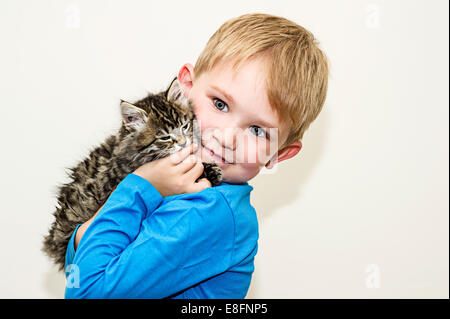 Portrait d'un garçon tenant un chaton Banque D'Images
