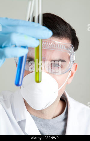 Scientist looking at liquid in test tubes Banque D'Images