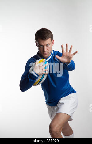 Rugby player exécute avec ballon de rugby Banque D'Images