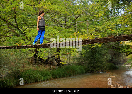 Des piétons sur le pont suspendu de la rivière Kotsalos Oreini (ountainous, 'm') Nafpaktia, Rethymnon, Grèce. Banque D'Images