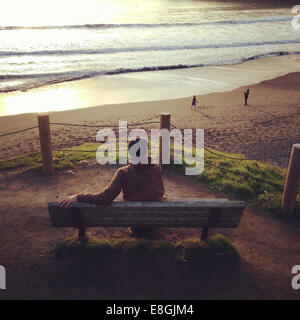 Homme assis sur le banc au coucher du soleil, Muir Beach, Marin, Californie, États-Unis Banque D'Images