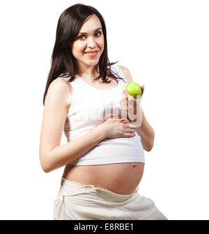 Happy young pregnant woman in white holding green apple. Isolated on white Banque D'Images