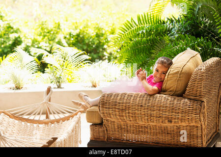 Hispanic girl sitting in armchair extérieur Banque D'Images