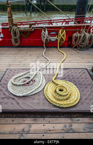 Montage des cordes enroulées sur le pont d'un boisé à vieux grand voilier. Banque D'Images