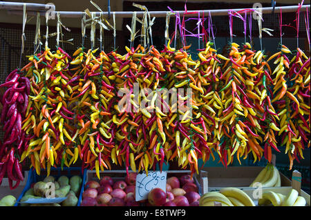 Un affichage de chaînes de piments colorés accrochés sur une street market stall dans Sorrento, Italie Banque D'Images