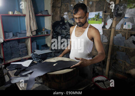 Dhaka, Bangladesh. 14Th Oct, 2014. Un travailleur du Bangladesh coupe le traité pour faire mousser ses chaussures à Hazaribagh. Dhaka, Bangladesh © Suvra Kanti Das/ZUMA/ZUMAPRESS.com/Alamy fil Live News Banque D'Images