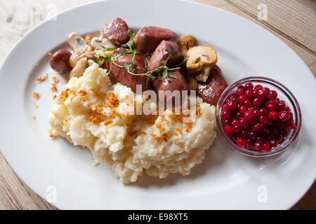 Close up sur plat délicieux saucisson de renne, champignons, purée de pommes et canneberges. Oslo, Ostlandet. La Norvège Banque D'Images