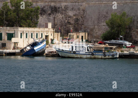 Bateaux utilisés pour amener les migrants à partir de la Libye a abandonné sur le rivage près de La Valette, Malte Banque D'Images