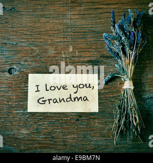 Un bouquet de fleurs de lavande et d'une note avec le texte je t'aime, grand-mère sur une table en bois Banque D'Images