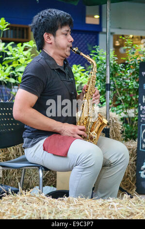 Jouer du saxophone au marché de fermiers, Bangkok, Thaïlande Banque D'Images