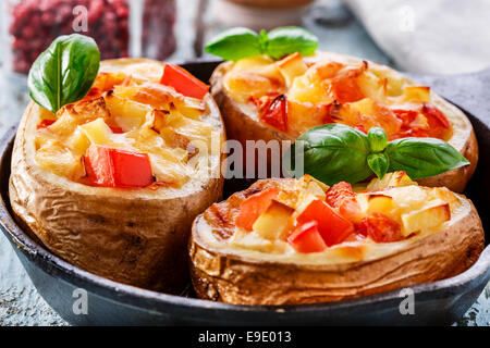 Pommes de terre farcies de fromage et les tomates dans une casserole Banque D'Images