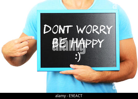 Man holding tableau noir dans les mains et en pointant le mot dont worry be happy Banque D'Images