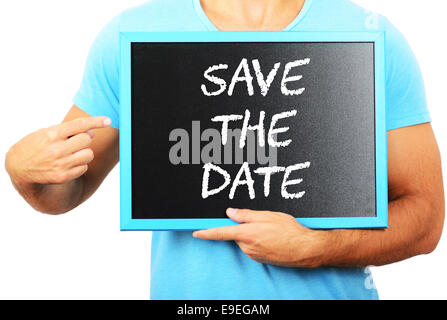 Man holding tableau noir dans les mains et en pointant le mot SAVE THE DATE Banque D'Images