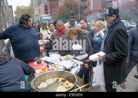 New York, USA. 26 octobre, 2014. Les Américains profiter de trottoir péruvienne fête en l'honneur d'El Senor de los Milagros (Seigneur des miracles) le dimanche après-midi, le 26 octobre 2014. Le Seigneur des miracles, illustrée par son image, est le symbole principal de la diaspora péruvienne à New York et ailleurs. Credit : Dorothy Alexander/Alamy Live News Banque D'Images