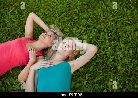 Deux jeunes filles se trouvent ensemble sur l'herbe et profiter Banque D'Images