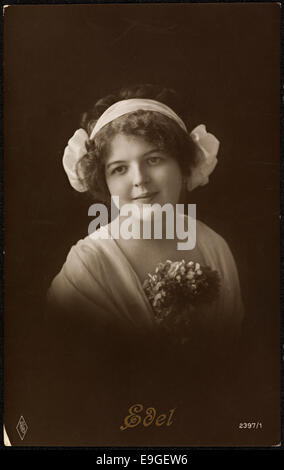 Une carte postale vintage d'une femme en tenue à la mode, peut-être du début du 20ème siècle. Cette image, publiée par Paul Fink Publisher, met en valeur une femme à la mode des années 1920-1930, un exemple clé de la mode vintage capturée dans un format carte postale. Banque D'Images