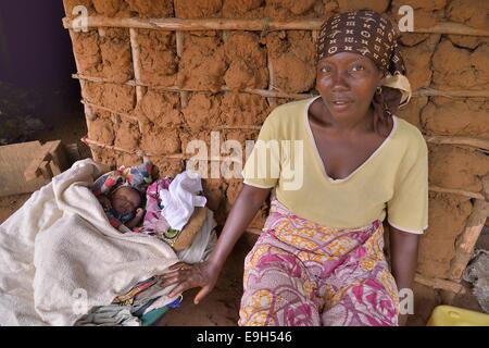 Femme avec un enfant assis devant sa hutte, près de Kent, région de l'Ouest, la Sierra Leone Banque D'Images