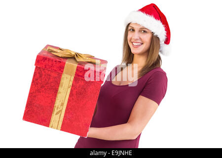 Pretty girl in santa hat holding gift box Banque D'Images