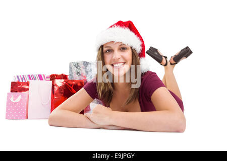 Brunette fête smiling at camera with gift bags Banque D'Images