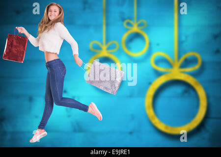 Image composite de jolie blonde with shopping bags Banque D'Images